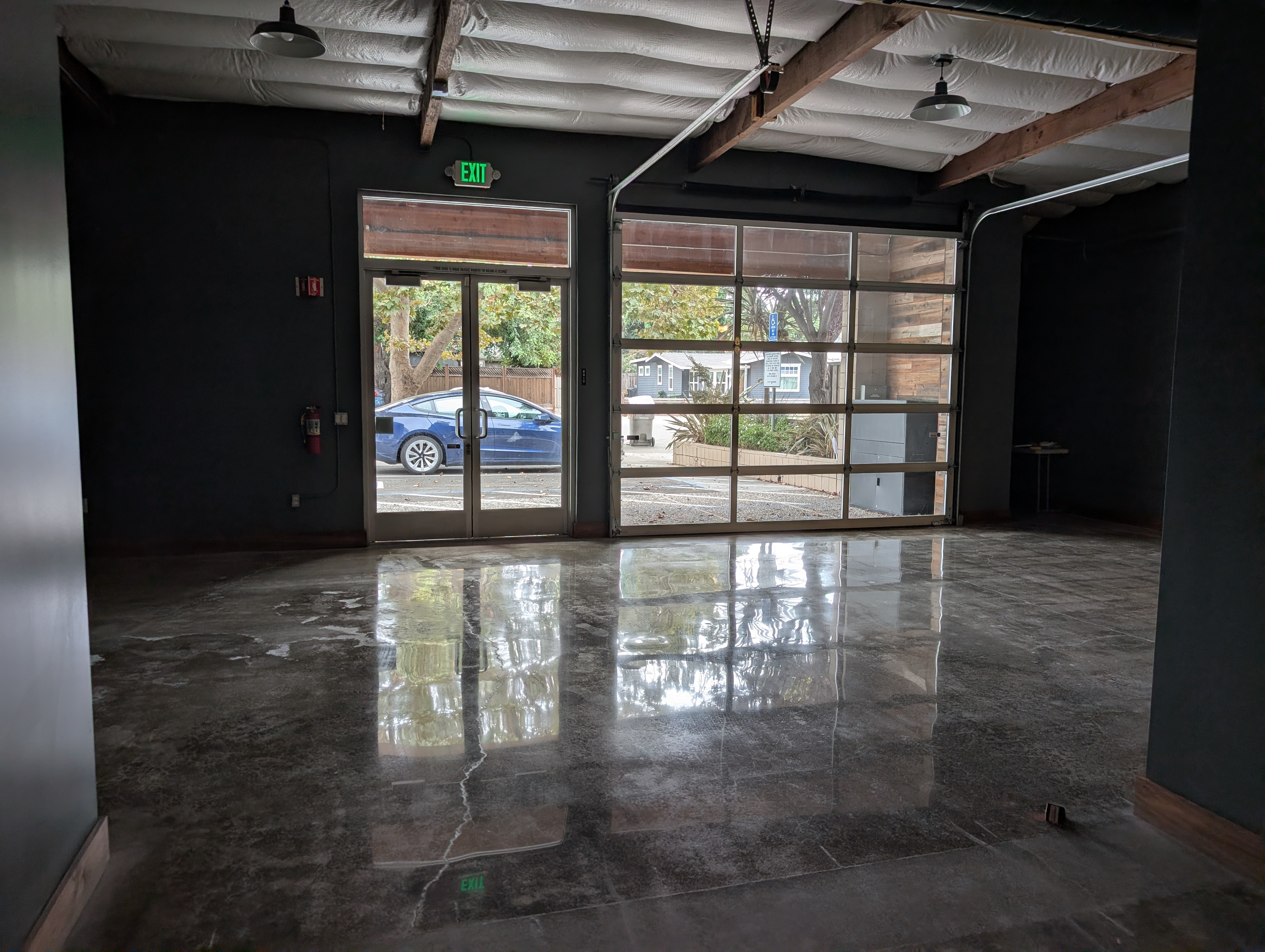 Office space with a reflection in a polished concrete floor.